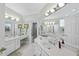 Bright bathroom featuring white cabinets, dual vanities, a separate shower, and large mirrors at 156 Yorkchester Way, Raleigh, NC 27615