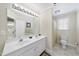 Bright bathroom featuring a double sink vanity, tile flooring, and a combination shower and tub at 156 Yorkchester Way, Raleigh, NC 27615