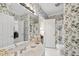 Charming bathroom features floral wallpaper, white fixtures, and a shower-tub combination at 156 Yorkchester Way, Raleigh, NC 27615