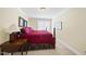 Comfortable bedroom features a bed, bedside table, natural light, and cozy ambiance at 156 Yorkchester Way, Raleigh, NC 27615