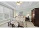 Comfortable bedroom features a ceiling fan, large window, and floral bedding for a restful retreat at 156 Yorkchester Way, Raleigh, NC 27615