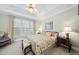 Inviting bedroom with a tray ceiling, soft lighting, and a floral-patterned bed for a serene atmosphere at 156 Yorkchester Way, Raleigh, NC 27615