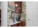 Cozy desk area with charming wallpaper and wood cabinetry offers a functional workspace at 156 Yorkchester Way, Raleigh, NC 27615