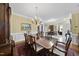 Elegant dining space boasting a wooden table, plush rug, chandelier, and ample seating at 156 Yorkchester Way, Raleigh, NC 27615