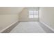 Bright, carpeted room with sloped ceilings, a large window, and neutral paint at 156 Yorkchester Way, Raleigh, NC 27615