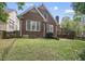 Charming brick home showcasing a well-maintained lawn and inviting backyard space at 156 Yorkchester Way, Raleigh, NC 27615