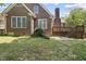Charming brick home showcasing a well-maintained lawn and inviting backyard space at 156 Yorkchester Way, Raleigh, NC 27615