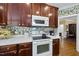 Close-up of a kitchen with wood cabinets, white countertop appliances, and a cozy, inviting atmosphere at 156 Yorkchester Way, Raleigh, NC 27615