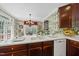 Bright kitchen with dark wood cabinetry, white countertops and fixtures, and ample counter space at 156 Yorkchester Way, Raleigh, NC 27615