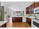 Well-lit kitchen with wood cabinetry, white countertops, and views to an adjacent dining area with french doors at 156 Yorkchester Way, Raleigh, NC 27615