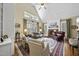 Elegant living room with vaulted ceilings, a fireplace, and abundant natural light from large windows at 156 Yorkchester Way, Raleigh, NC 27615