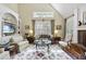 Bright living room with a fireplace, built-in shelving, and a large window providing natural light at 156 Yorkchester Way, Raleigh, NC 27615