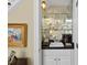 Cozy wet bar featuring mirrored shelving, a sink, and storage cabinets in a convenient location at 156 Yorkchester Way, Raleigh, NC 27615