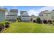 Well-manicured backyard featuring a lush lawn, black metal fence and neighboring houses at 1641 Silo Ridge Dr, Wake Forest, NC 27587