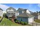 Exterior view of home with a spacious backyard, garage, screened porch and landscaping at 1641 Silo Ridge Dr, Wake Forest, NC 27587
