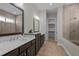 Bathroom featuring double vanity, neutral tile, and a separate tub and shower at 1641 Silo Ridge Dr, Wake Forest, NC 27587