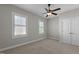 Bright bedroom with neutral carpet, two windows, ceiling fan and closet at 1641 Silo Ridge Dr, Wake Forest, NC 27587