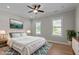 A primary bedroom features a ceiling fan, large windows, and a serene atmosphere at 1641 Silo Ridge Dr, Wake Forest, NC 27587