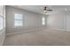 Spacious bedroom featuring neutral carpet, two windows, and ceiling fan at 1641 Silo Ridge Dr, Wake Forest, NC 27587