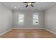 Bright bedroom with wood floors, two windows, ceiling fan and neutral paint at 1641 Silo Ridge Dr, Wake Forest, NC 27587