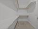 Walk-in closet with built-in shelving and neutral carpet at 1641 Silo Ridge Dr, Wake Forest, NC 27587