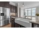 Kitchen with stainless refrigerator, granite counter tops, farmhouse sink and hardwood floors at 1641 Silo Ridge Dr, Wake Forest, NC 27587