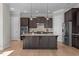 Gourmet kitchen featuring a granite island, stainless appliances, tile backsplash, and custom cabinetry at 1641 Silo Ridge Dr, Wake Forest, NC 27587