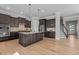 Open kitchen boasts a large island, granite counters, stainless appliances, and seamless access to other rooms at 1641 Silo Ridge Dr, Wake Forest, NC 27587