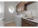 Laundry room with front load washer and dryer, sink and cabinets at 1641 Silo Ridge Dr, Wake Forest, NC 27587
