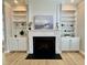 Cozy living room with a fireplace and white built-in shelving on both sides, filled with decorations at 1641 Silo Ridge Dr, Wake Forest, NC 27587