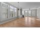 Bright living room with hardwood floors, large windows with shutters, and a fireplace for a cozy ambiance at 1641 Silo Ridge Dr, Wake Forest, NC 27587