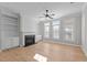 Bright living room featuring a fireplace, built-in bookshelves, beautiful flooring and natural light at 1641 Silo Ridge Dr, Wake Forest, NC 27587