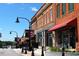 Charming street view with brick buildings, flags, and retail shops at 1641 Silo Ridge Dr, Wake Forest, NC 27587