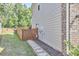 Side yard of the property featuring a wooden fence, stepping stones, and a walkway along the home at 1808 Capstone Dr, Durham, NC 27713