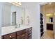 Modern bathroom featuring a single sink vanity with brown cabinets and views into another bathroom space at 1808 Capstone Dr, Durham, NC 27713