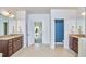 Bathroom featuring dual vanities, tile floors, and an adjacent doorway at 1808 Capstone Dr, Durham, NC 27713
