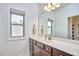 Well-lit bathroom featuring a single sink vanity with dark wood cabinets and a large window at 1808 Capstone Dr, Durham, NC 27713