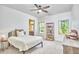 Bright bedroom features a neutral color palette, two windows, and a view into an attached bathroom at 1808 Capstone Dr, Durham, NC 27713