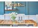 Dining room features a wooden table, white chairs, and an accent wall with shelves at 1808 Capstone Dr, Durham, NC 27713
