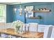 Light fixture hangs over dining table with decor and white flower centerpiece in a dining room at 1808 Capstone Dr, Durham, NC 27713