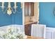Dining room looking to butlers pantry has an accent wall and lovely light fixture at 1808 Capstone Dr, Durham, NC 27713