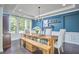 Dining room features a wood table, upholstered chairs, and an accent wall at 1808 Capstone Dr, Durham, NC 27713