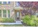 Close up of the front door with lush landscaping and a well-manicured lawn at 1808 Capstone Dr, Durham, NC 27713