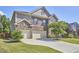 Spacious home featuring a three-car garage, brick facade, and a well-kept green lawn at 1808 Capstone Dr, Durham, NC 27713