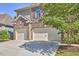 Three car garage with ample parking space and lush landscaping around the property at 1808 Capstone Dr, Durham, NC 27713