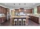 Spacious kitchen with stainless steel appliances, a large island, and dark cabinets at 1808 Capstone Dr, Durham, NC 27713
