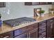 Close-up of kitchen featuring granite countertops, dark cabinets, and tile backsplash at 1808 Capstone Dr, Durham, NC 27713