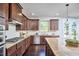 Modern kitchen featuring stainless steel appliances, granite countertops, and beautiful dark wood cabinets at 1808 Capstone Dr, Durham, NC 27713