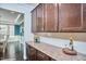 Kitchen space featuring granite countertops, tile backsplash, and dark wood cabinetry at 1808 Capstone Dr, Durham, NC 27713