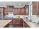 Modern kitchen featuring dark cabinets, granite countertops, and a herringbone backsplash at 1808 Capstone Dr, Durham, NC 27713